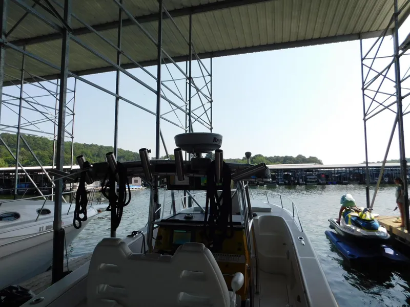 Slide: The Image of 2004 Fountain 38 Sportfish CC docked under a covered marina. - 13