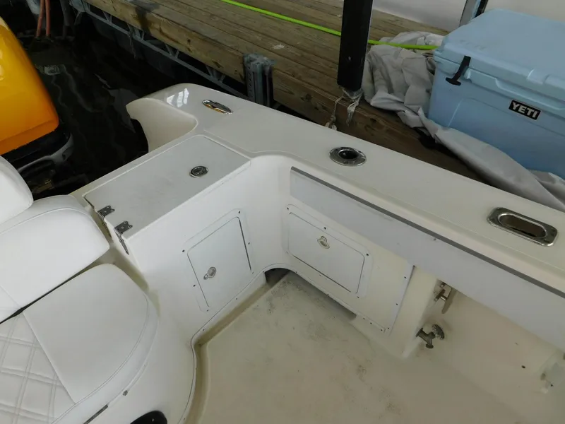 Slide: The Image of 2004 Fountain 38 Sportfish CC boat interior with storage compartments and seating. - 15
