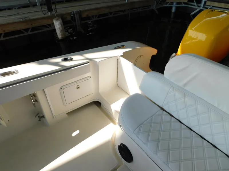 Slide: The Image of 2004 Fountain 38 Sportfish CC boat interior with white seating and storage compartment. - 16
