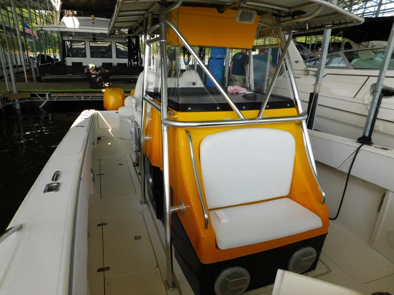 Slide: The Image of 2004 Fountain 38 Sportfish CC boat with vibrant yellow console and seating, docked in marina. - 19