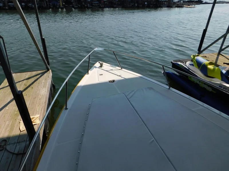 Slide: The Image of 2004 Fountain 38 Sportfish CC boat docked on calm water. - 22