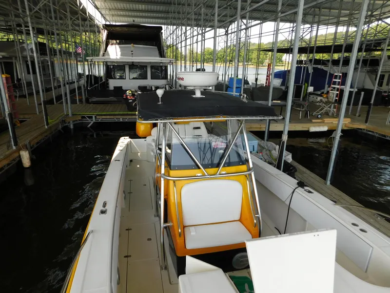 Slide: The Image of 2004 Fountain 38 Sportfish CC docked in a covered marina. - 26