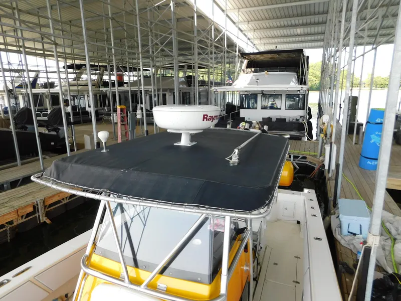 Slide: The Image of 2004 Fountain 38 Sportfish CC docked in a covered marina. - 28