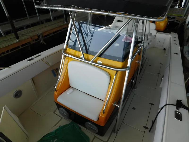 Slide: The Image of 2004 Fountain 38 Sportfish CC boat with yellow console and seating. - 29