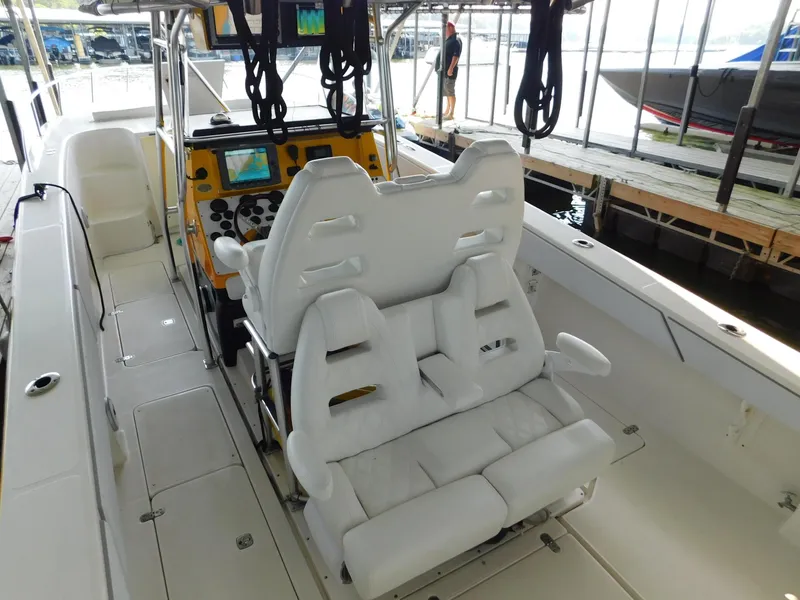 Slide: The Image of 2004 Fountain 38 Sportfish CC boat interior with white seating and control panel. - 36