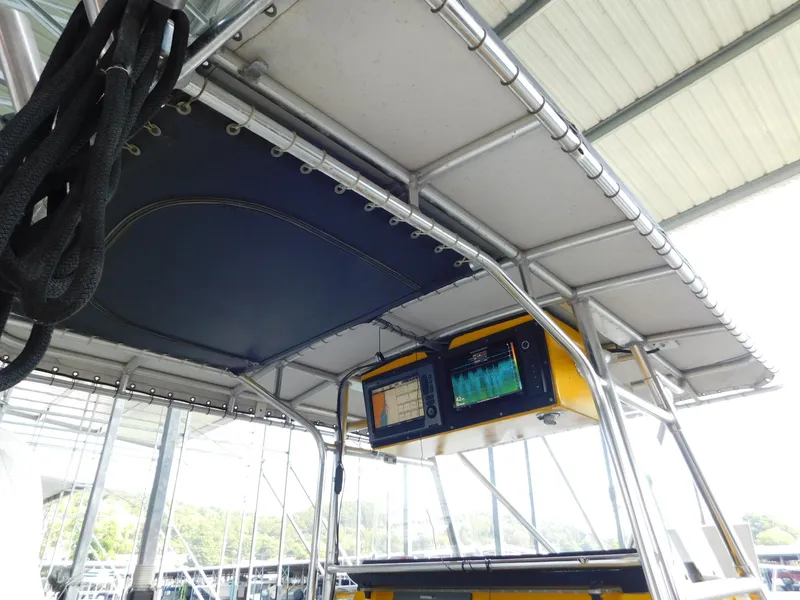 Slide: The Image of 2004 Fountain 38 Sportfish CC boat with canopy and electronic navigation equipment. - 37