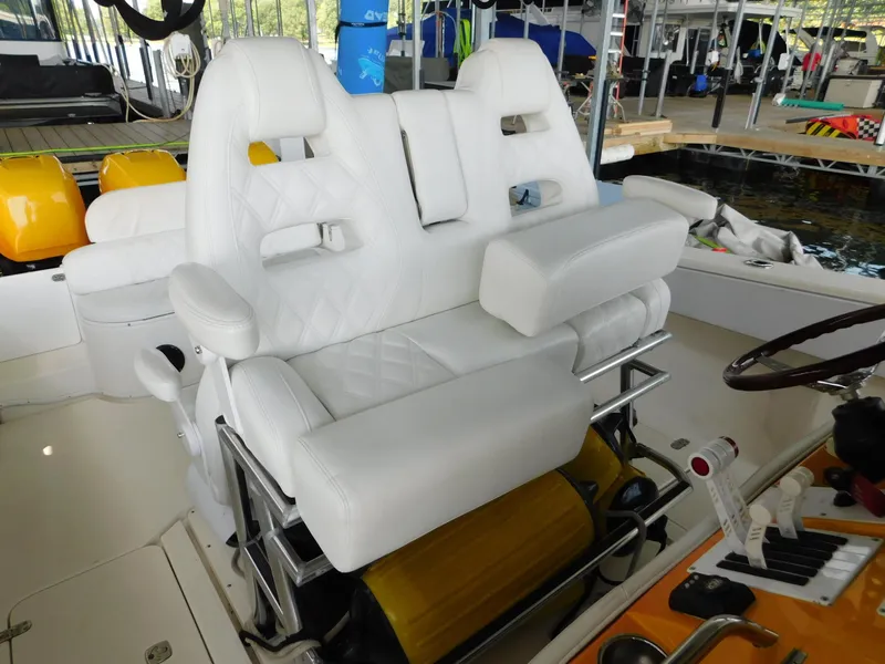 Slide: The Image of 2004 Fountain 38 Sportfish CC boat with white cushioned seating at the helm. - 38