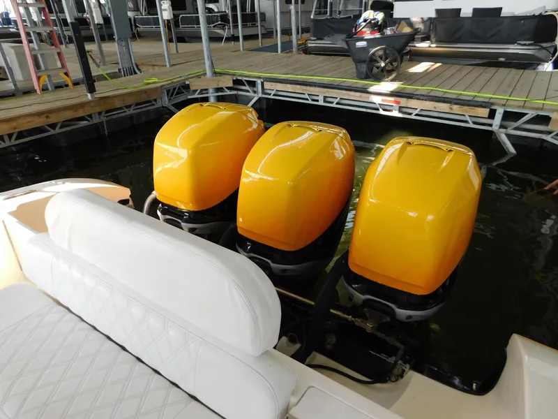 Slide: The Image of Triple yellow outboard engines on 2004 Fountain 38 Sportfish CC boat at dock. - 4