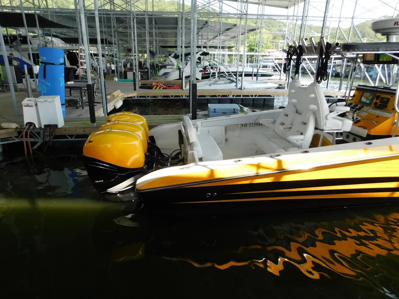 Slide: The Image of 2004 Fountain 38 Sportfish CC with yellow engines docked in a marina. - 41