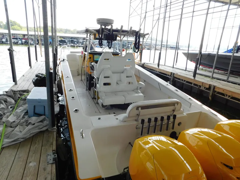 Slide: The Image of 2004 Fountain 38 Sportfish CC boat docked with yellow engines and white seating. - 46