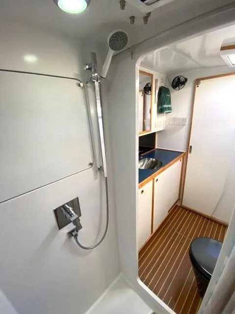 Slide: The Image of Bathroom interior of 2018 Chris White Atlantic 70 "SAPHIRA" yacht, featuring shower and wooden flooring. - 18