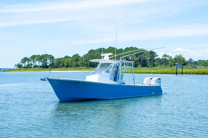 Slide: The Image of Custom 31 2020 boat on calm water with scenic background. - 11