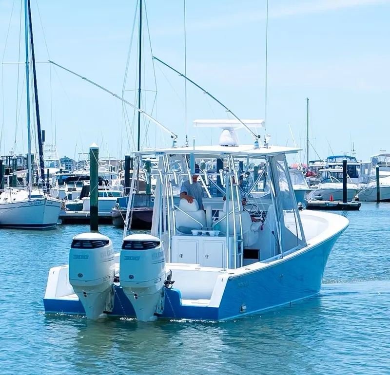 Slide: The Image of Custom 31 2020 boat with twin engines in a marina. - 16