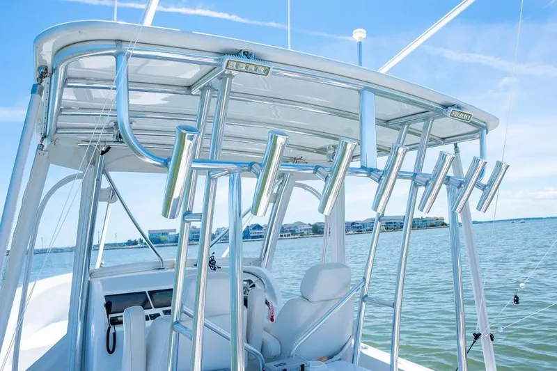 Slide: The Image of Custom 31 boat, 2020 model, with rod holders on a sunny day. - 18