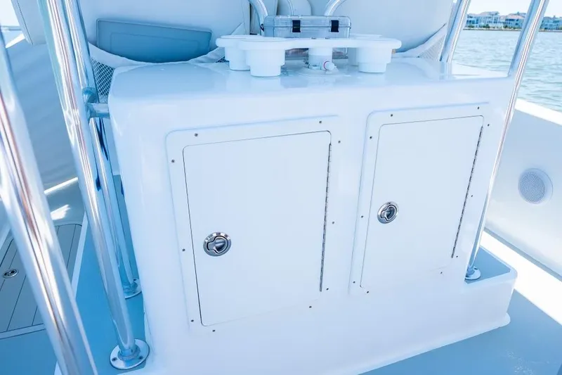 Slide: The Image of Custom 31 boat console with storage compartments, 2020 model, on a sunny day. - 19