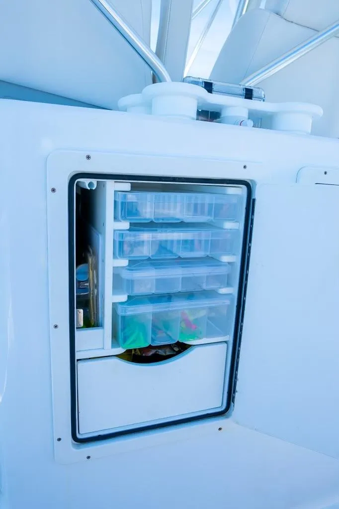 Slide: The Image of Custom 31 2020 boat storage compartment with organized tackle boxes - 20