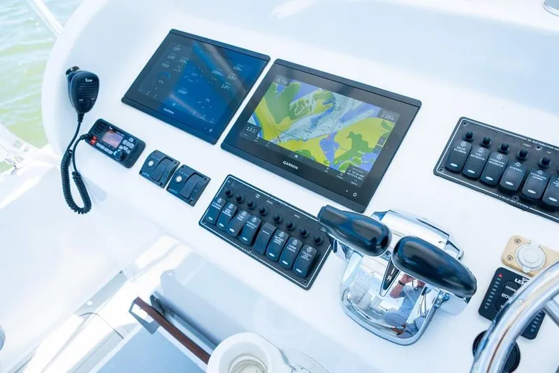 Slide: The Image of Boat control panel with dual screens, navigation system, and communication devices, Custom 31, 2020 model. - 22