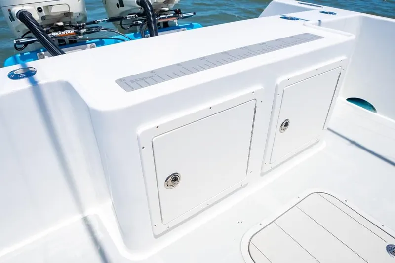 Slide: The Image of Custom 31 boat, 2020 model, featuring storage compartments and dual outboard motors. - 23