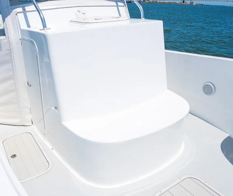 Slide: The Image of Custom 31 boat, 2020 model, white seating area, ocean background. - 25