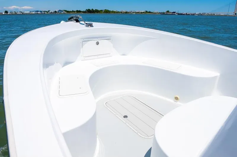 Slide: The Image of Custom 31 boat, 2020 model, white deck, on calm blue water. - 31