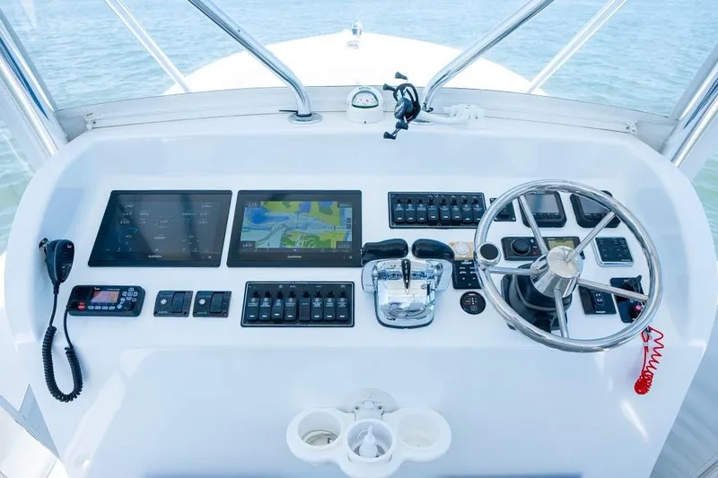Slide: The Image of Modern boat control panel with navigation screens, steering wheel, and communication devices, Custom 31, 2020 model. - 32