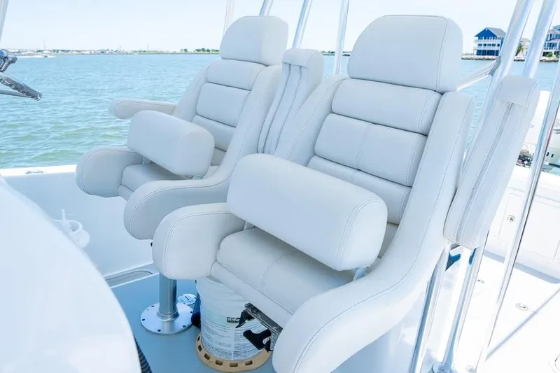 Slide: The Image of Luxurious white leather boat seats on a Custom 31 model, 2020, with a scenic water backdrop. - 34
