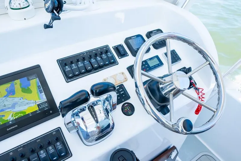 Slide: The Image of Modern boat control panel with steering wheel, navigation system, and throttle controls, Custom 31, 2020 model. - 35