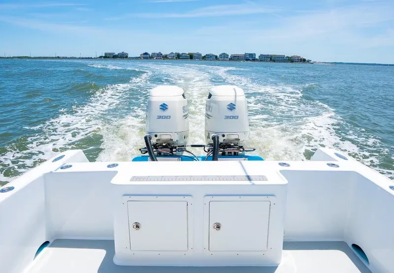 Slide: The Image of Custom 31 boat with twin 300 horsepower engines cruising on open water, 2020 model. - 36