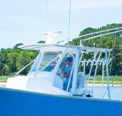 Slide: The Image of Custom 31 boat, 2020 model, cruising on a serene lake with lush green trees in the background. - 5