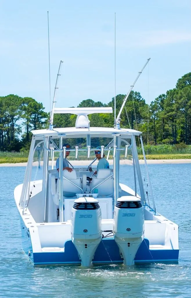 Slide: The Image of Custom 31 boat 2020 model with dual engines on a serene lake. - 7