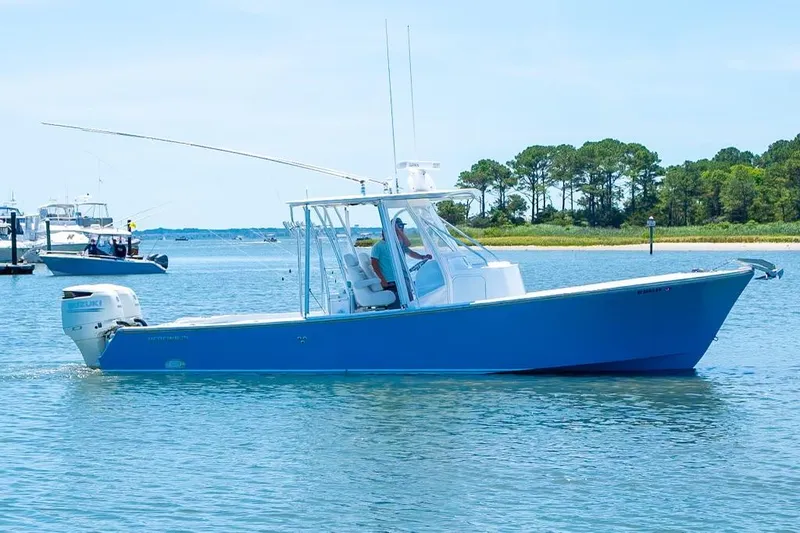 Slide: The Image of Custom 31 2020 model blue fishing boat on calm water near shore. - 9
