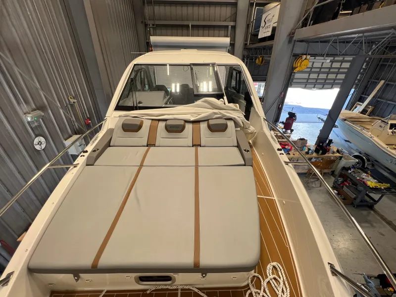 Slide: The Image of 2023 Beneteau Gran Turismo 32 yacht with sunbathing area in a boatyard. - 10