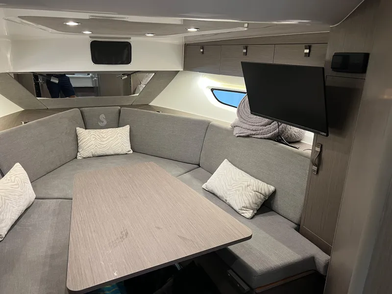 Slide: The Image of Interior of 2023 Beneteau Gran Turismo 32 with modern seating and TV. - 11