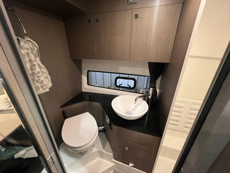 Slide: The Image of Modern bathroom in 2023 Beneteau Gran Turismo 32 yacht with sink, toilet, and storage cabinets. - 15