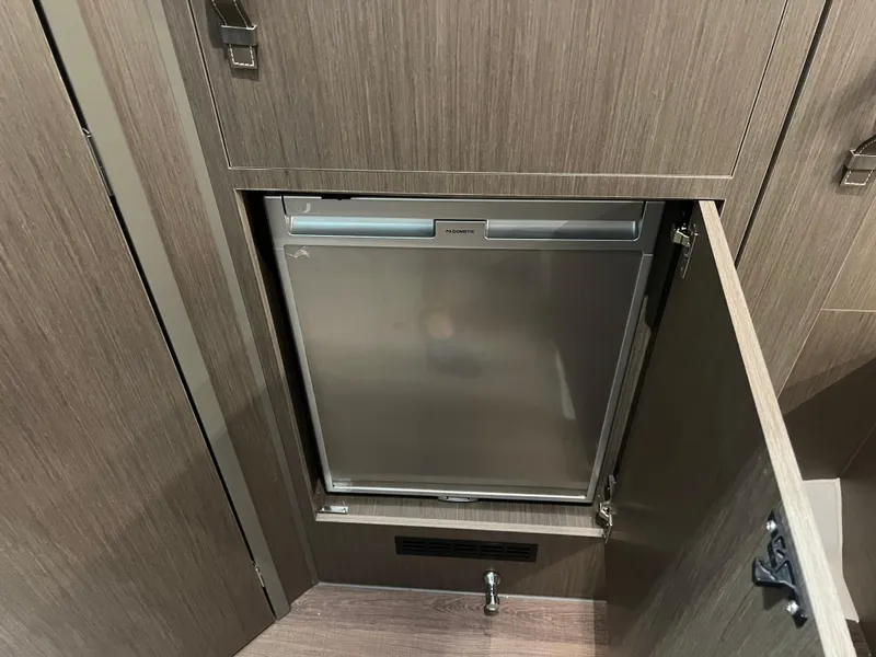 Slide: The Image of Compact refrigerator in the 2023 Beneteau Gran Turismo 32 yacht interior. - 16