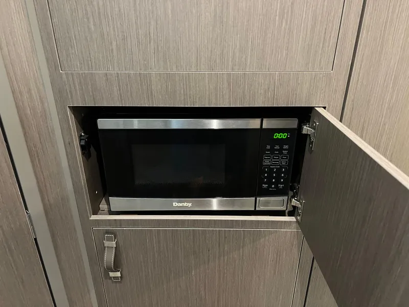 Slide: The Image of Built-in microwave in the 2023 Beneteau Gran Turismo 32 yacht kitchen. - 17