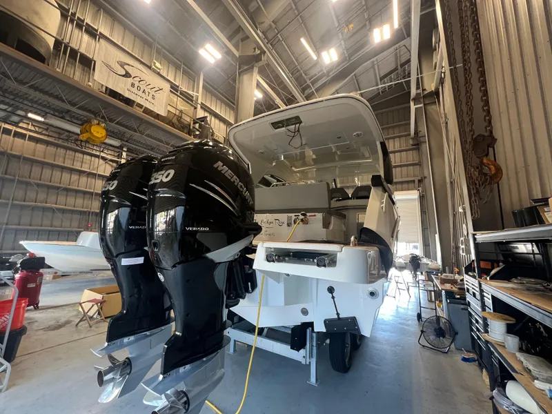 Slide: The Image of 2023 Beneteau Gran Turismo 32 in a boatyard with twin Mercury 350 engines. - 2