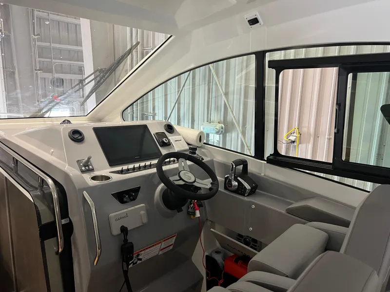 Slide: The Image of Interior cockpit of 2023 Beneteau Gran Turismo 32 with modern controls and steering wheel. - 5