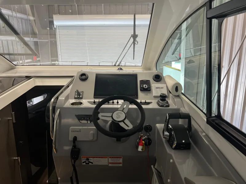 Slide: The Image of 2023 Beneteau Gran Turismo 32 helm station with steering wheel and navigation controls. - 6