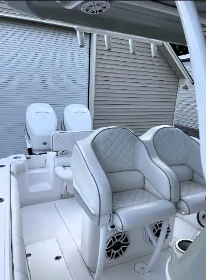 Slide: The Image of 2020 Glasstream 328 Pro-XS boat interior with dual seats and twin outboard motors. - 16