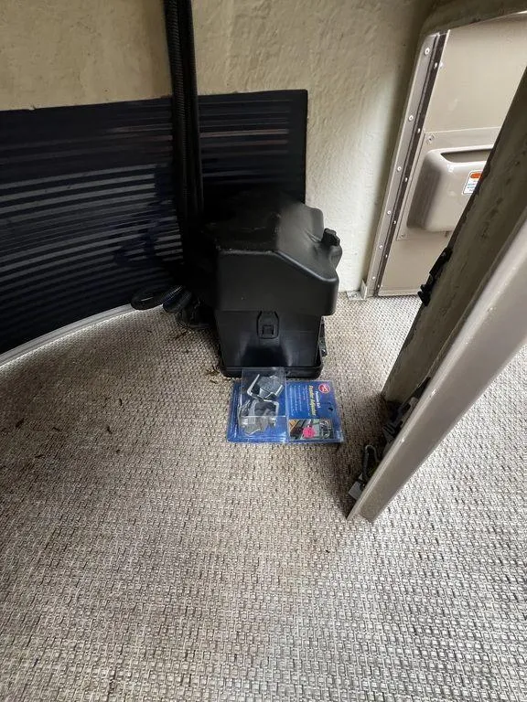 Slide: The Image of 2019 Bennington 25 SPDXP boat interior with battery box and hardware. - 11