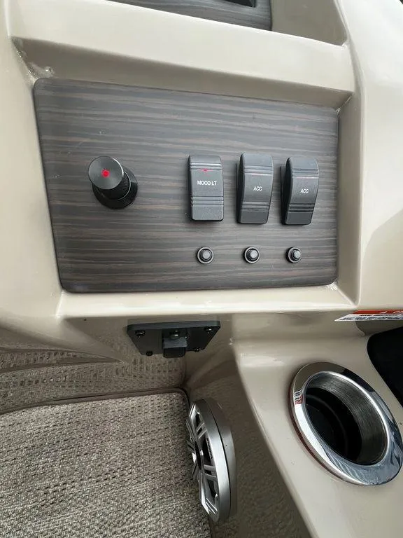 Slide: The Image of Control panel of a 2019 Bennington 25 SPDXP boat with switches and cup holder. - 12