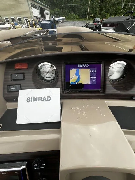 Slide: The Image of 2019 Bennington 25 SPDXP dashboard with Simrad navigation system. - 16
