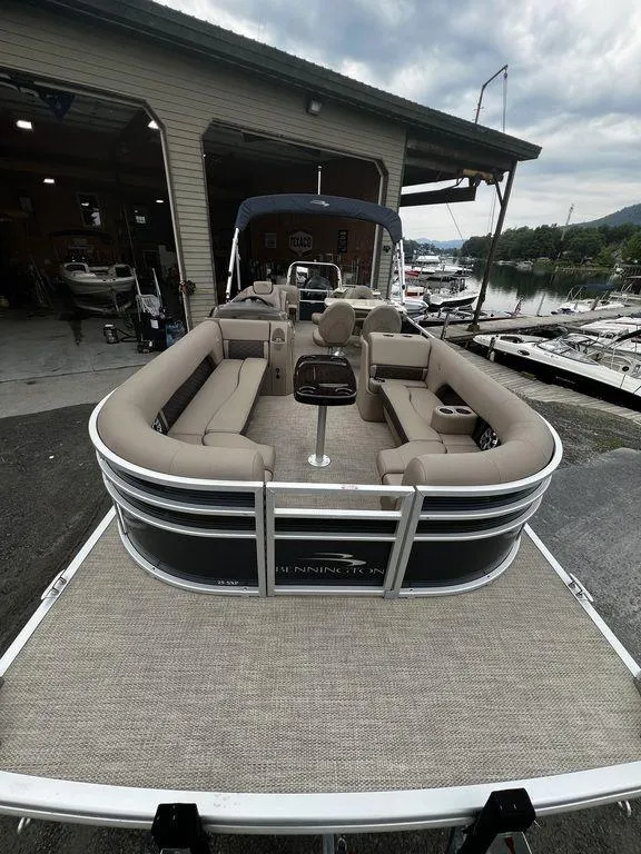 Slide: The Image of 2019 Bennington 25 SPDXP pontoon boat docked at a marina. - 18