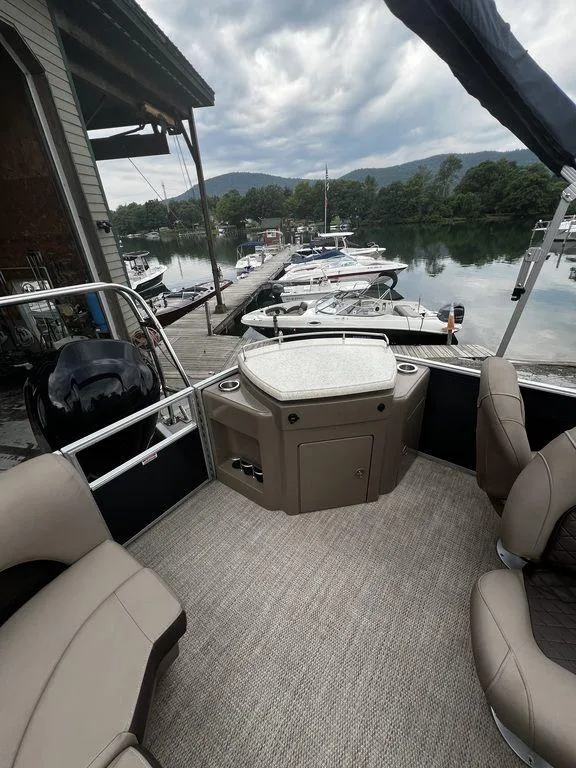 Slide: The Image of 2019 Bennington 25 SPDXP pontoon boat interior at a marina. - 7
