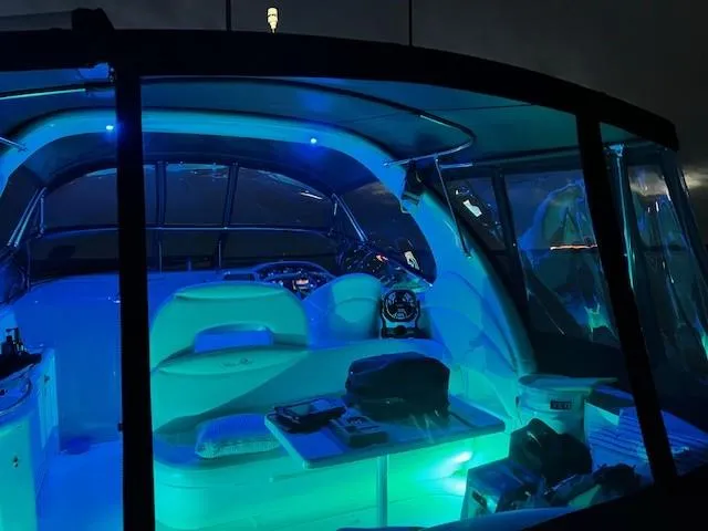 Slide: The Image of Interior of a 2002 Sea Ray 360 Sundancer boat illuminated with blue LED lights at night. - 11