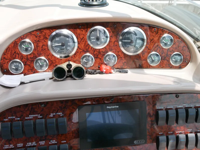 Slide: The Image of Dashboard of a 2002 Sea Ray 360 Sundancer boat with gauges and controls. - 14