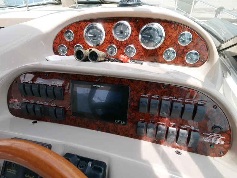 Slide: The Image of Control panel of a 2002 Sea Ray 360 Sundancer boat with gauges and switches. - 16