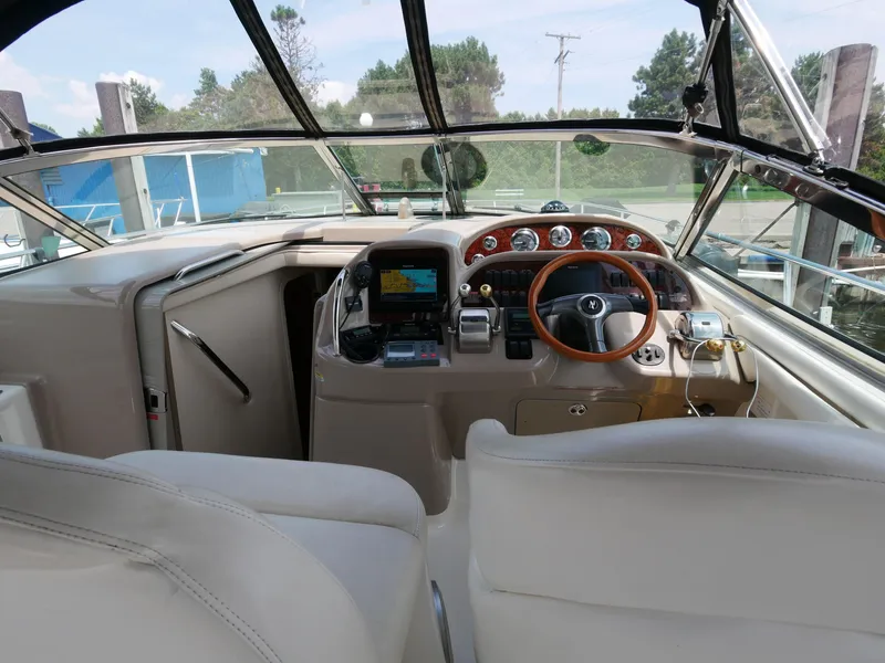 Slide: The Image of 2002 Sea Ray 360 Sundancer boat cockpit with steering wheel and navigation equipment. - 17
