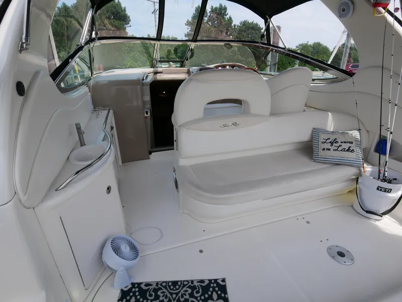 Slide: The Image of Interior of a 2002 Sea Ray 360 Sundancer boat with seating and helm. - 22